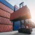 Forklift working in at Container cargo harbor. Logistics concept inside the shipping, import, and export industries. Forklift working in at Container cargo harbor. Logistics concept inside the shipping, import, and export industries.